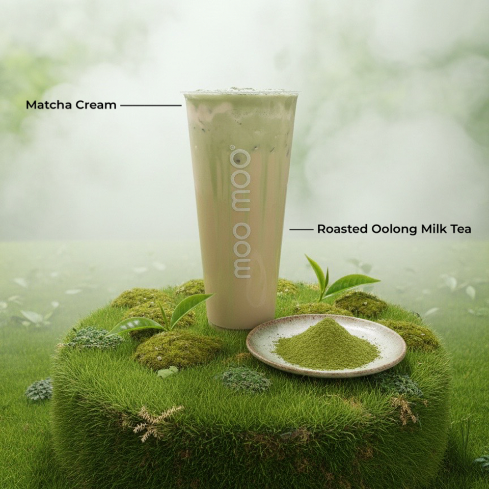 Non-dairy roasted oolong milk tea with matcha cream, accompanied by a plate of matcha powder on a mossy green landscape.